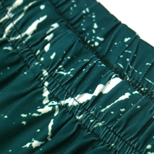 Detail of elastic waistband and tie-dye fabric on women's high waist beach shorts
