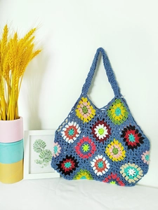 Detailed close-up of handmade crochet tote bag with colorful granny square floral patterns