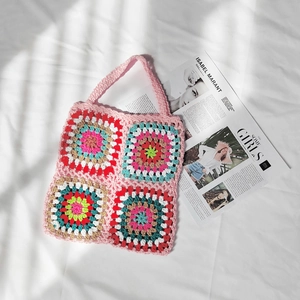 Detailed close-up of handmade crochet granny square tote bag with colorful patchwork pattern