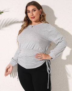 Detail of grey plus size sweatshirt with adjustable drawstring waist and pleated texture