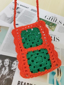 Handmade woven crossbody phone bag featuring orange and green vibrant crochet square patterns