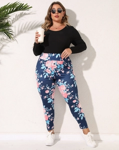 Detail of floral print plus size leggings with high waist and realistic flower pattern