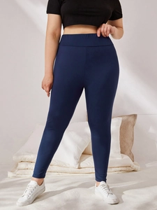 Detail view of high waist dark blue plus size leggings with elastic waistband design