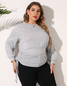 Detail of adjustable drawstring waist and side pleats on grey plus size sweatshirt