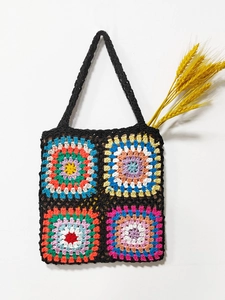 Detailed close-up of handmade granny square crochet tote bag with vibrant floral patterns