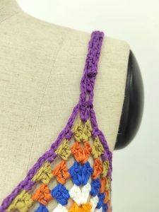 Detailed close-up of handmade crochet stitching and colorful geometric patterns