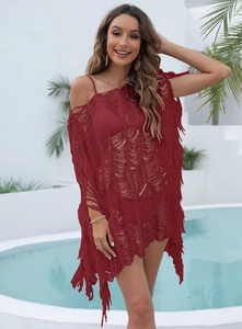 Detail view of red hollow knit beach cover-up featuring intricate tassel hem and crochet pattern