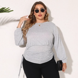Detail of adjustable waist drawstrings and pleated texture on grey long sleeve sweatshirt