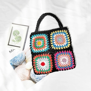 Detailed shot of handmade granny square crochet tote with colorful patchwork patterns
