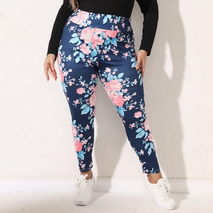 Detail of high-waisted plus size leggings with pink rose floral print on navy blue fabric