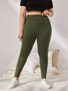 Detail of high waisted plus size olive green leggings with elastic waistband fit
