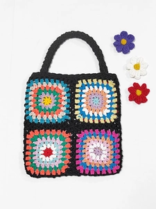 Close-up of handmade crochet granny square handbag with colorful vibrant floral patterns