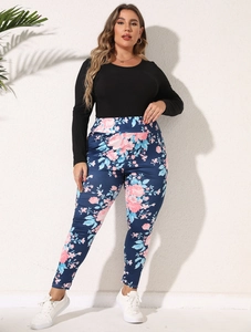 Close-up of floral print leggings paired with a black long sleeve top and white sneakers