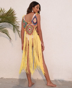 Detail of handmade colorful crochet granny square beach cover-up with long yellow tassels