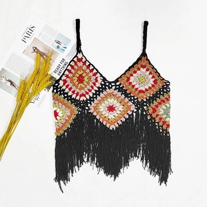 Detail of bohemian crochet tank top with geometric diamond patterns and long black fringe