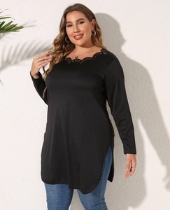 Detail of plus size black tunic with scalloped cutout neckline and side slit hem