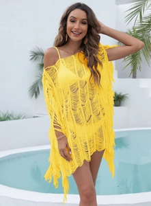 Detail of yellow beach cover-up featuring fringe texture and woven hollow design