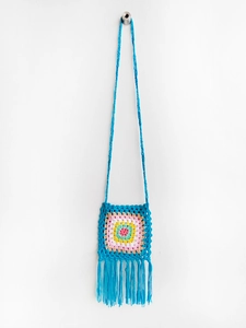Detailed view of hand-crocheted boho crossbody bag with rainbow sun flower and fringe