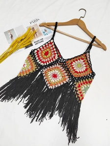Detail of bohemian crochet tank top featuring multi-color granny squares and black fringe