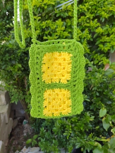 Detail of crochet weave texture and wave edges on a handmade green boho shoulder bag