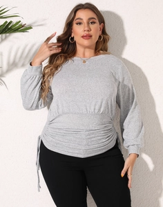 Macro shot of light gray plus size sweatshirt with adjustable side drawstring waist detail