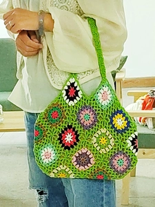 Detailed close-up of handmade crochet tote bag with colorful floral granny square patterns