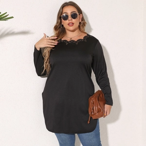 Detail of scalloped eyelet neckline and long sleeves on a black plus size tunic top