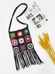 Detail of colorful granny square crochet bag with fringe and bohemian floral pattern