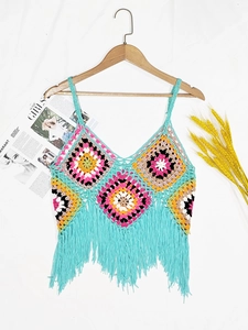 Detail of bohemian crochet tank top with colorful granny squares and long tassel fringe