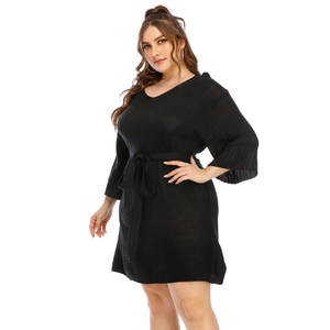 Detail of V-neckline and adjustable waist belt on black knitted plus size dress