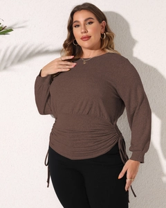 Detail of ruched waist with adjustable ties on a brown plus size long sleeve top