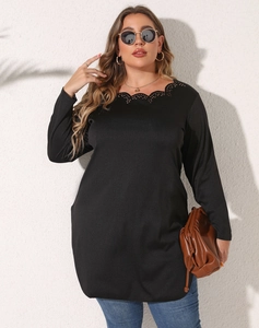 Detail of elegant black long sleeve top featuring laser-cut hollowed lace neckline