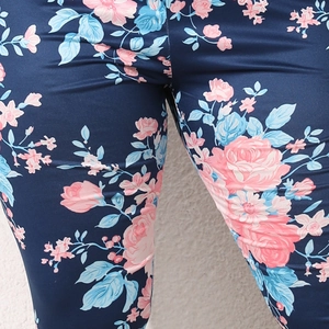 Close-up of floral print leggings showing pink rose patterns on navy blue stretch fabric