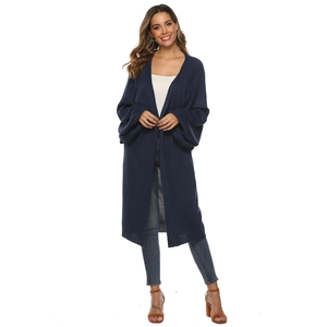 Detail of navy knit cardigan featuring loose lantern sleeves and open front design