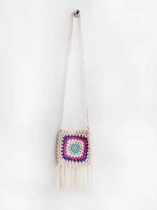 Close-up of handmade crochet crossbody bag with colorful patterns and long tassels