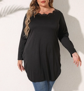 Detailed view of the scalloped laser-cut lace neckline on a black long sleeve plus size top