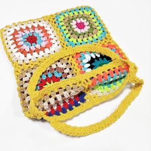 Close-up of handmade crochet granny square tote bag with colorful patchwork patterns