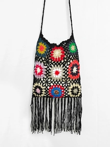 Detail of bohemian crochet shoulder bag featuring colorful floral patterns and long tassels