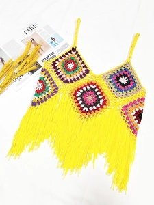 Detailed view of handmade crochet crop top with colorful mandala patterns and long yellow tassels