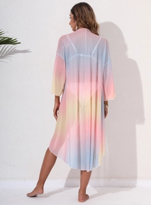 Detail of sheer tie-dye beach cover-up showing rainbow gradient mesh fabric from the back