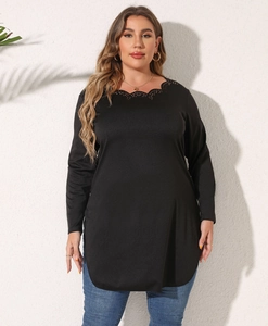 Close-up of elegant scalloped neckline on this black plus size long sleeve tunic top