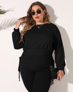 Detail of waist ruching and side drawstring on this black asymmetrical fitted sweatshirt