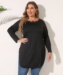 Detail of scalloped eyelet neckline on a black long sleeve tunic with side slits