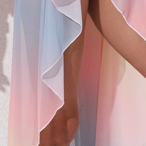 Close-up of the sheer tie-dye mesh fabric with vibrant rainbow gradient and soft pleats
