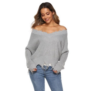 Close-up of grey off-shoulder knit sweater featuring distressed frayed edges and ribbed texture