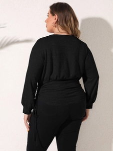 Rear view of black plus size sweatshirt featuring adjustable drawstring waist and pleated texture