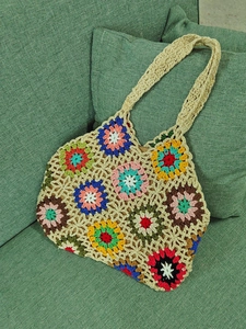 Detailed view of handmade colorful crochet tote bag with interior lining and straps