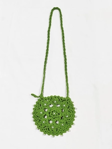Detail of green handmade crochet round bag with hollow floral patterns and white pearls