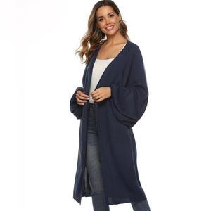 Detail of loose knit texture and stylish lantern sleeves on a navy long cardigan