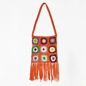 Colorful handmade crochet shoulder bag with floral patterns and vibrant long tassels
